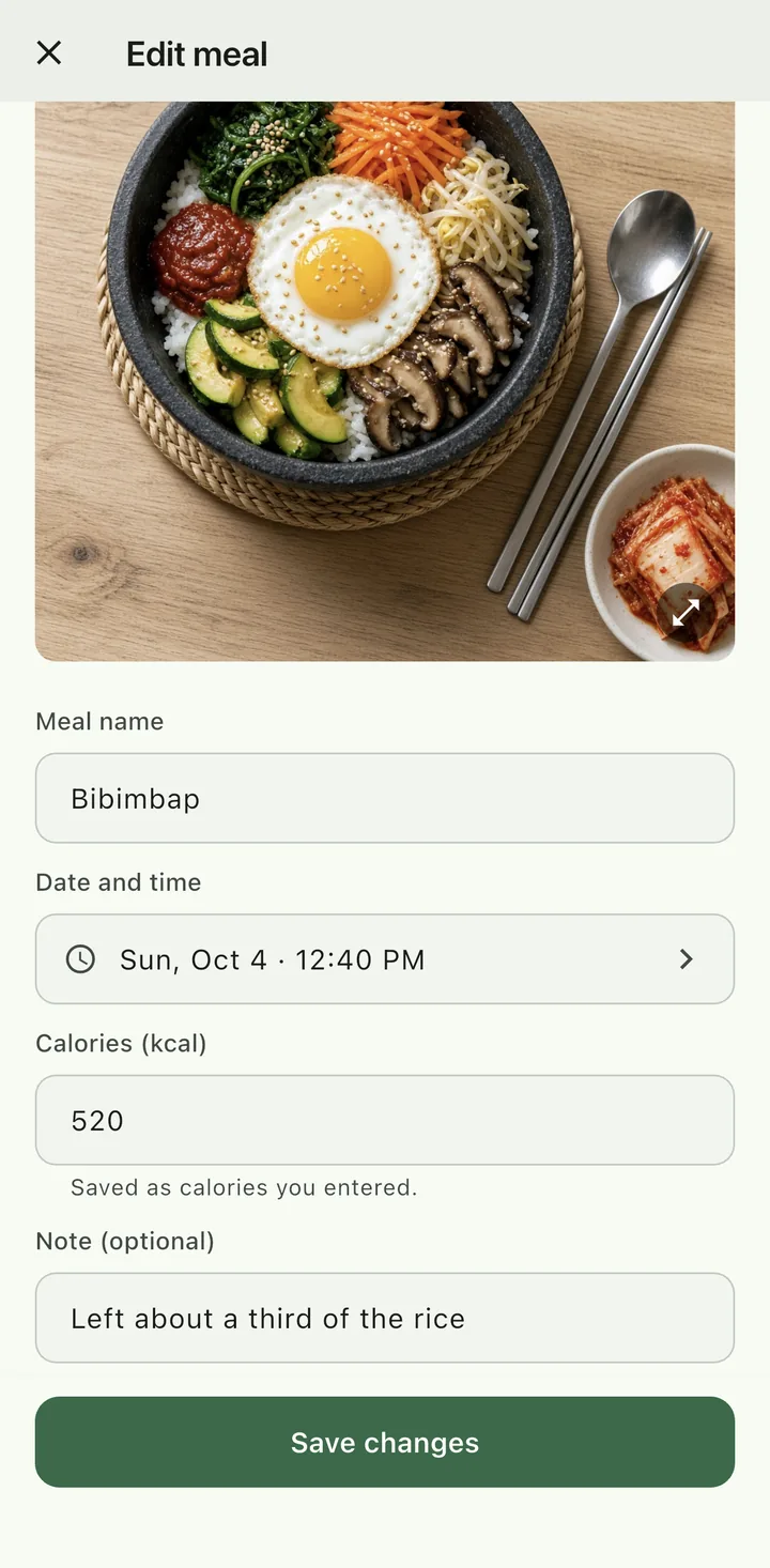 Edit meal screen, sample data. Below a bibimbap photo: meal name ‘Bibimbap’, Sun, Oct 4, 12:40 PM, 520 kcal with a note that it is saved as calories you entered, the note ‘Left about a third of the rice’, and a Save changes button.